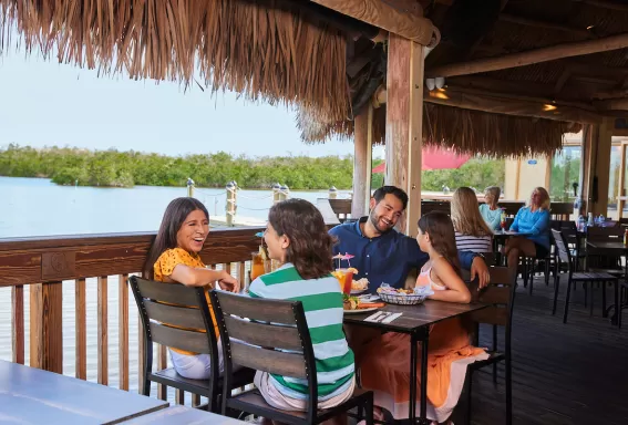 A family enjoys at meal on an outdoor deck at Coconut Jacks in Bonita Springs